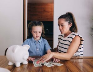 Mother teaching her child about saving money