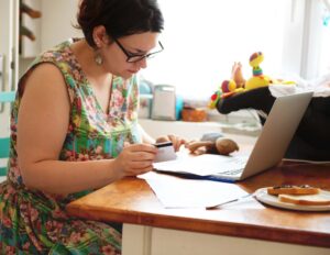 Confident single mom paying bills online