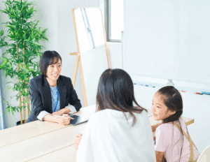 Parent reflecting on debt while balancing caregiving responsibilities at home.