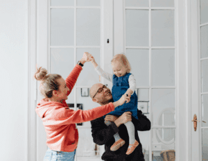 Family of a child with disabilities celebrating financial progress and stability.